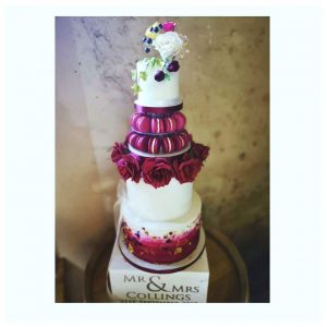 Deep burgundy wedding cake with sugar roses